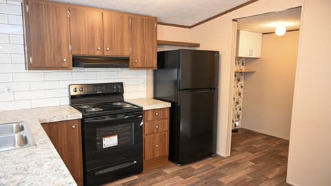 Kitchen at 31 blue water Drive, Cicero, IN — Updated kitchen with granite counters and black appliances.