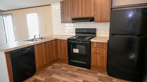 Kitchen at 31 blue water Drive, Cicero, IN — Updated kitchen with granite counters and black appliances.