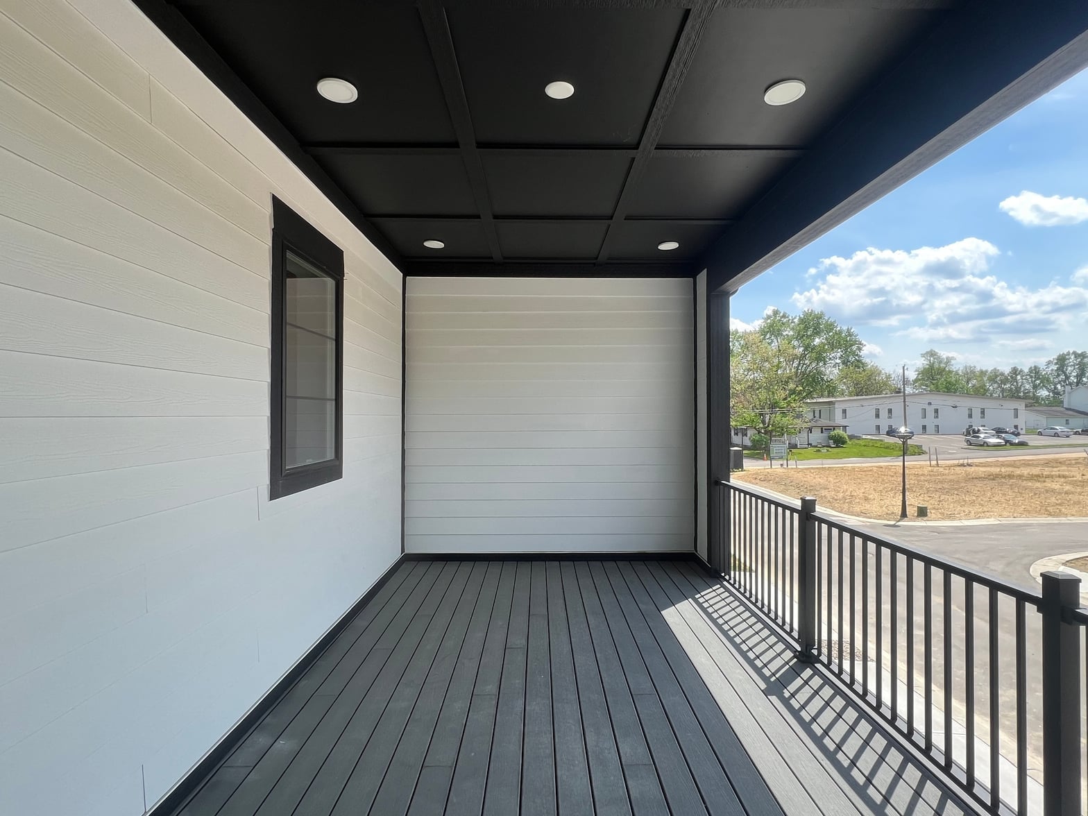 Modern covered deck with integrated garage access and ambient lighting.