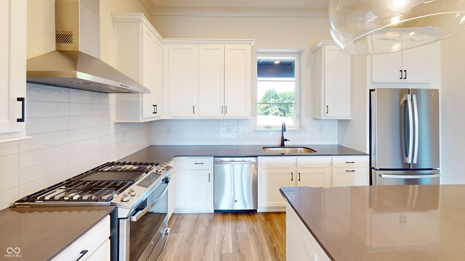 Chef's kitchen with premium appliances and bright finishes throughout.