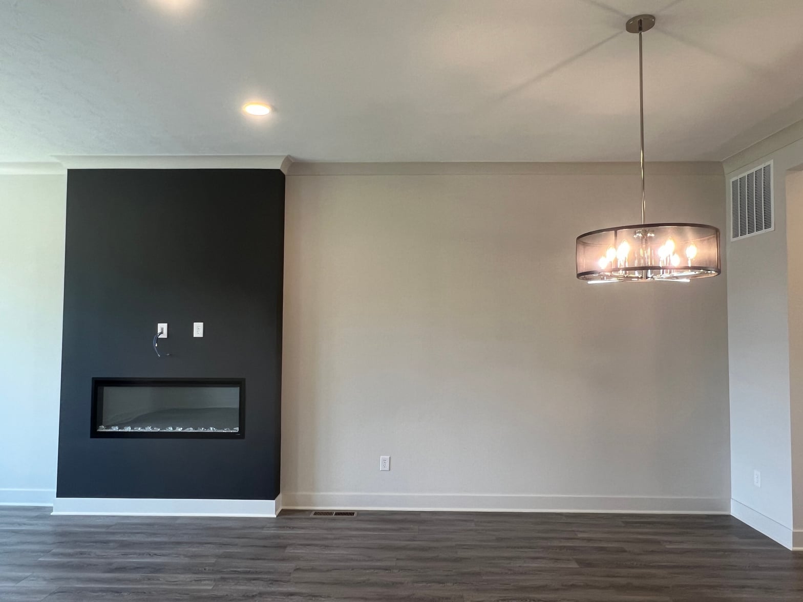 Sleek modern dining with statement fireplace accent wall.