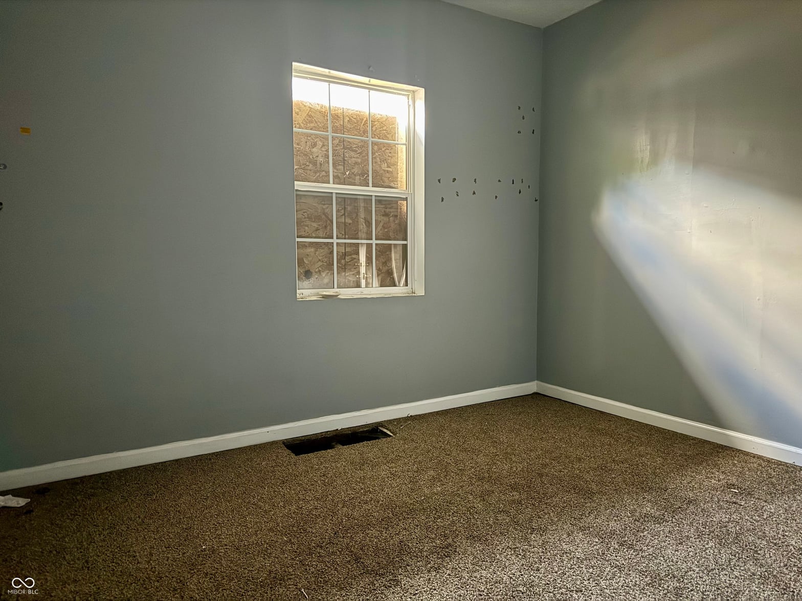 Bedroom at 642 N Oxford Street, Indianapolis, IN — Bright bedroom with fresh paint and new carpet throughout.