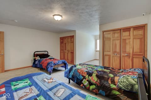 Bedroom at 303 Wellington Overlook, Noblesville, IN — Large bedroom with multiple beds and ample closet space.