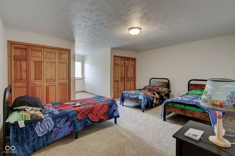 Bedroom at 303 Wellington Overlook, Noblesville, IN — Large bedroom with multiple beds and ample storage.