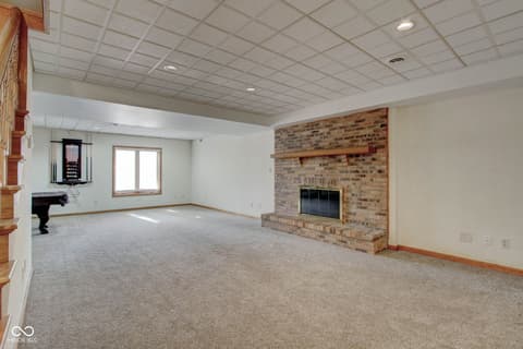 Family room at 303 Wellington Overlook, Noblesville, IN — Spacious family room with classic brick fireplace.