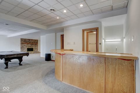 Basement at 303 Wellington Overlook, Noblesville, IN — Spacious finished basement with wet bar and fireplace.