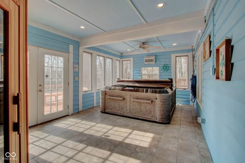 Outdoor living area at 303 Wellington Overlook, Noblesville, IN — Bright coastal-style covered porch with nautical charm.
