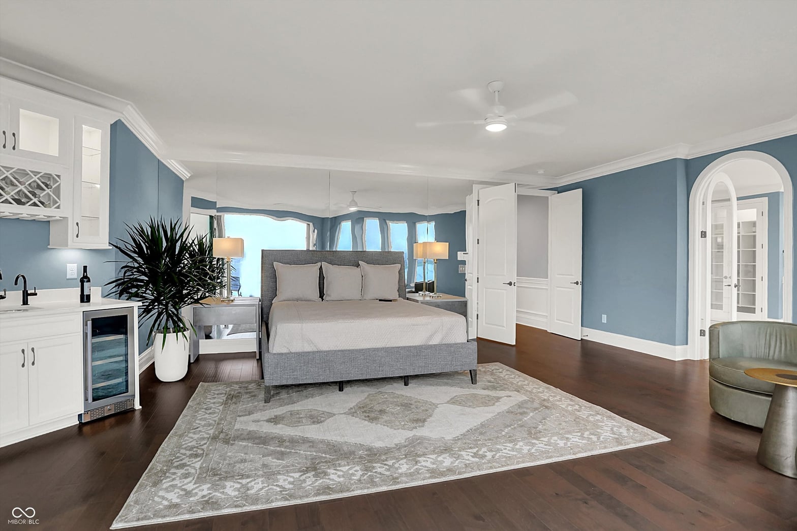 Luxurious primary suite with kitchenette and water views.