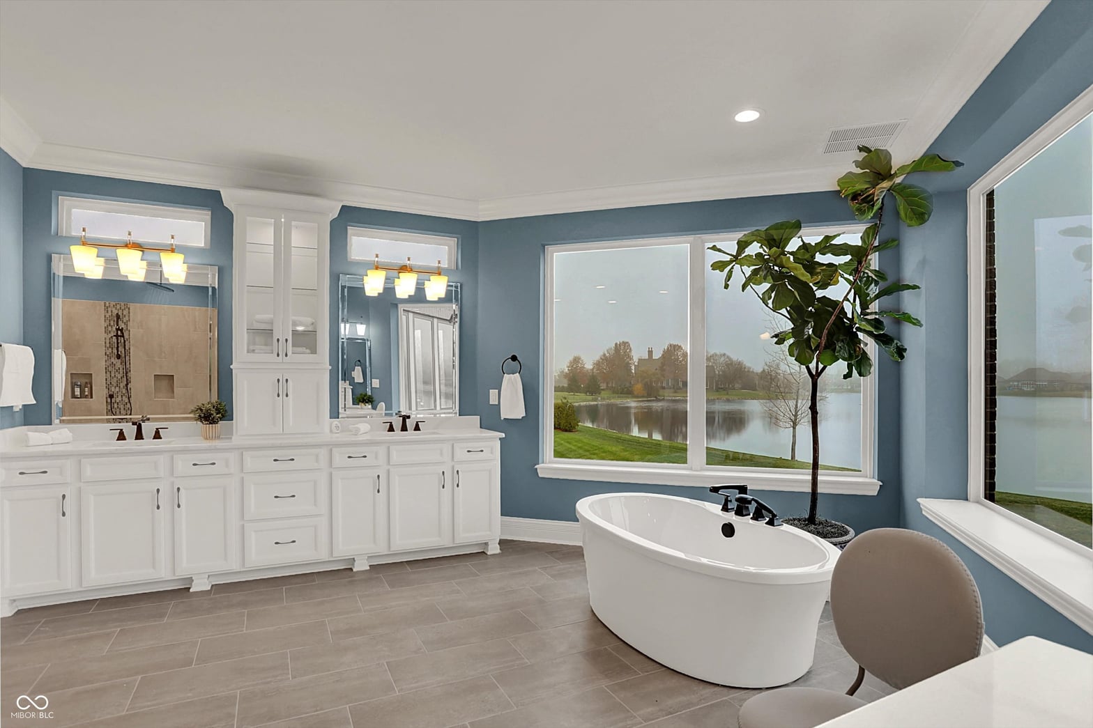 Luxurious primary bath with scenic water views.