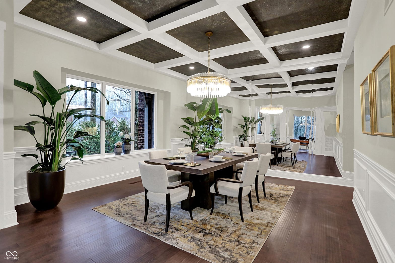 Elegant dining room with coffered ceilings and abundant natural light.