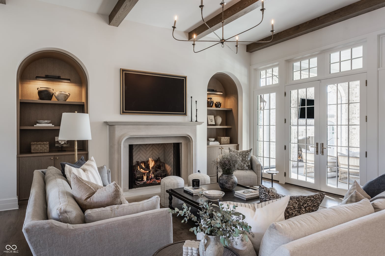 Elegant living room with fireplace and built-in shelving.