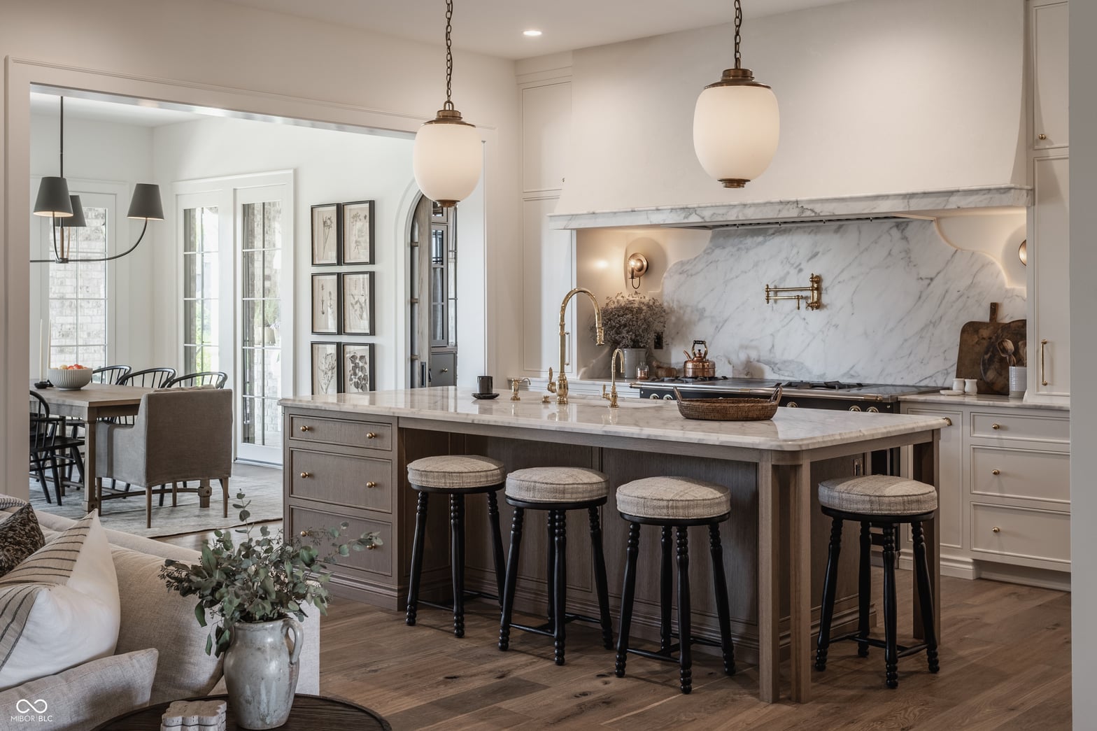 Luxury kitchen with marble island and brass accents.