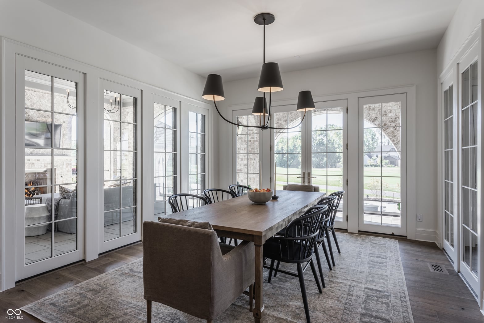 Bright dining room with extensive French doors and natural light.