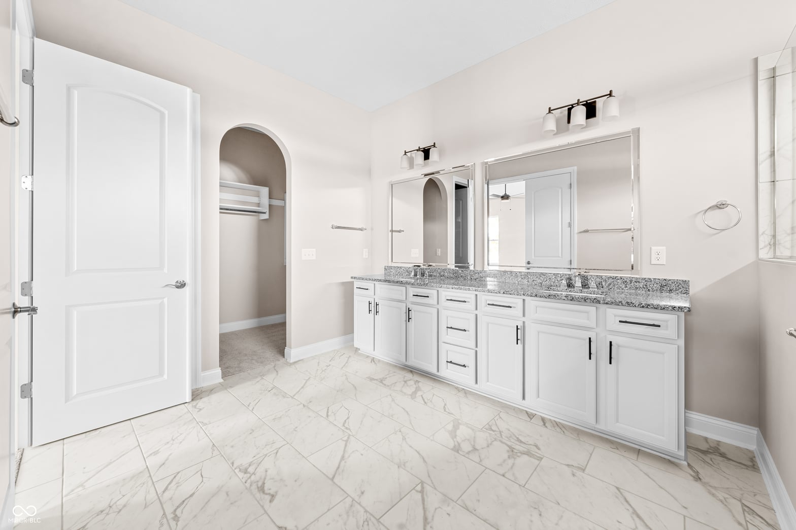 Primary bathroom at 4248 Stone Lake Drive, Zionsville, IN — Luxurious primary bath with dual vanity and marble flooring.
