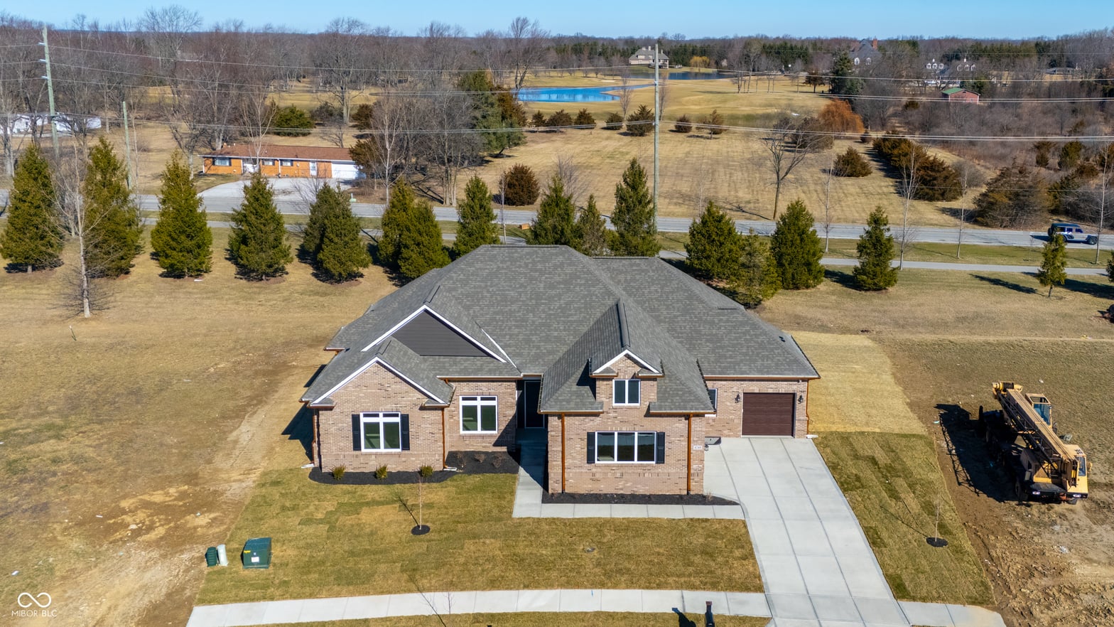 Aerial view at 4248 Stone Lake Drive, Zionsville, IN — New brick home on expansive lot with mature trees.