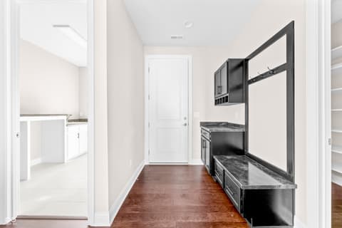 Laundry room at 4248 Stone Lake Drive, Zionsville, IN — Sleek modern laundry room with marble and black cabinetry.