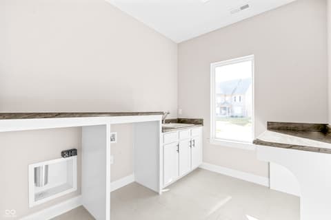 Laundry room at 4248 Stone Lake Drive, Zionsville, IN — Bright, modern laundry room with abundant counter space.