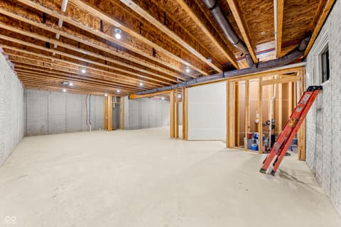 Basement at 4248 Stone Lake Drive, Zionsville, IN — Spacious unfinished basement with soaring exposed beams.