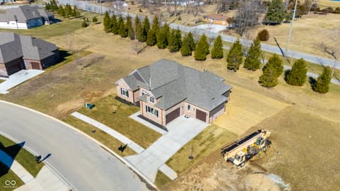 Aerial view at 4248 Stone Lake Drive, Zionsville, IN — New brick home on large landscaped lot with two-car garage.