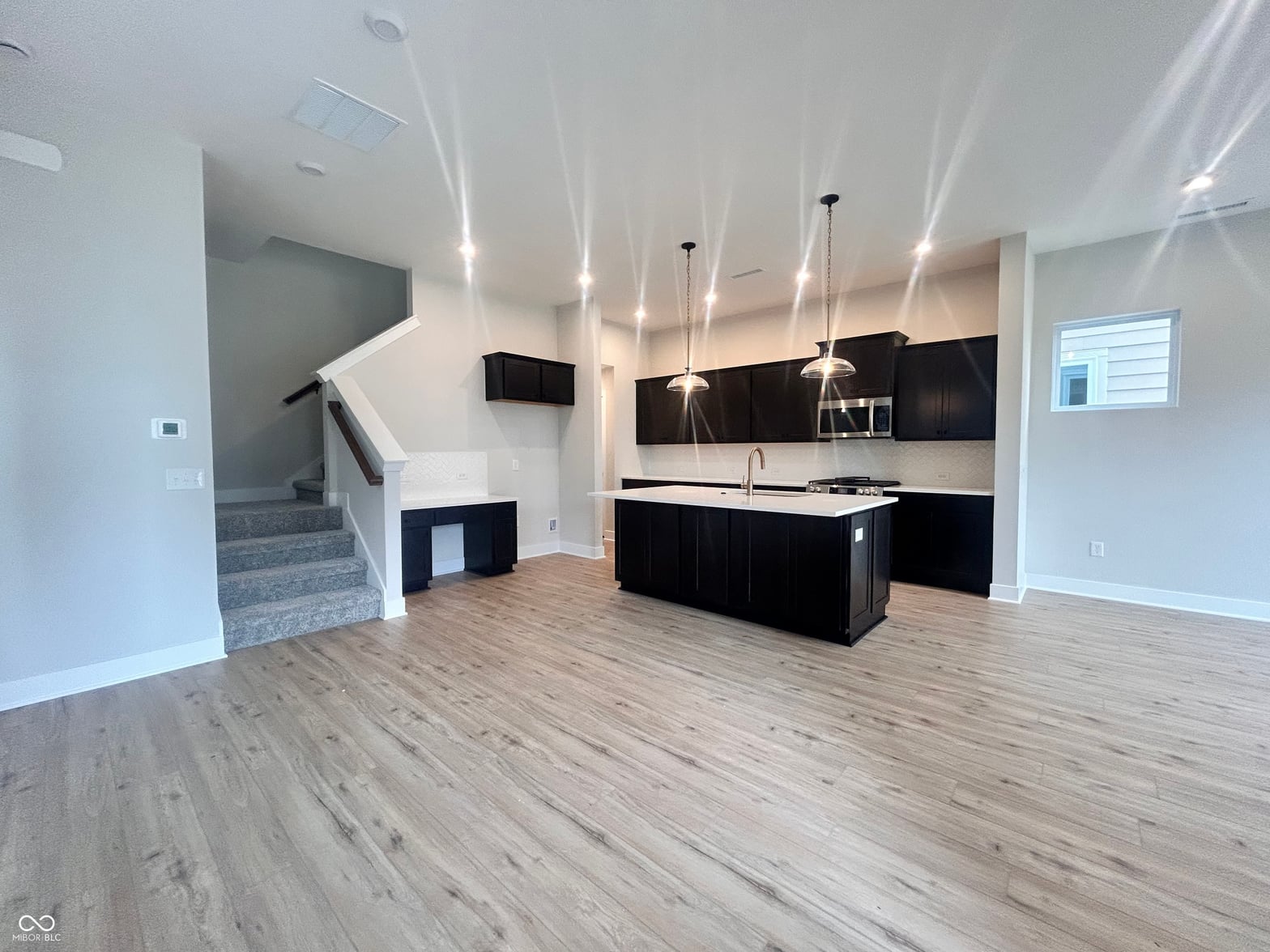 Kitchen at 745 Madelyn Drive, Carmel, IN — Stunning modern kitchen with black cabinetry and island.