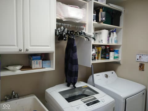 Laundry room at 5983 Clearview Drive, Carmel, IN — Bright, organized laundry room with ample custom storage.