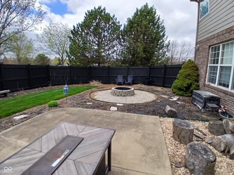 Outdoor living area at 5983 Clearview Drive, Carmel, IN — Private backyard oasis with fire pit and entertaining patio.