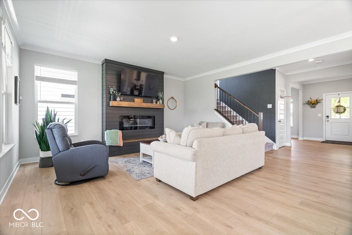 Bright open living space with modern fireplace and hardwood.