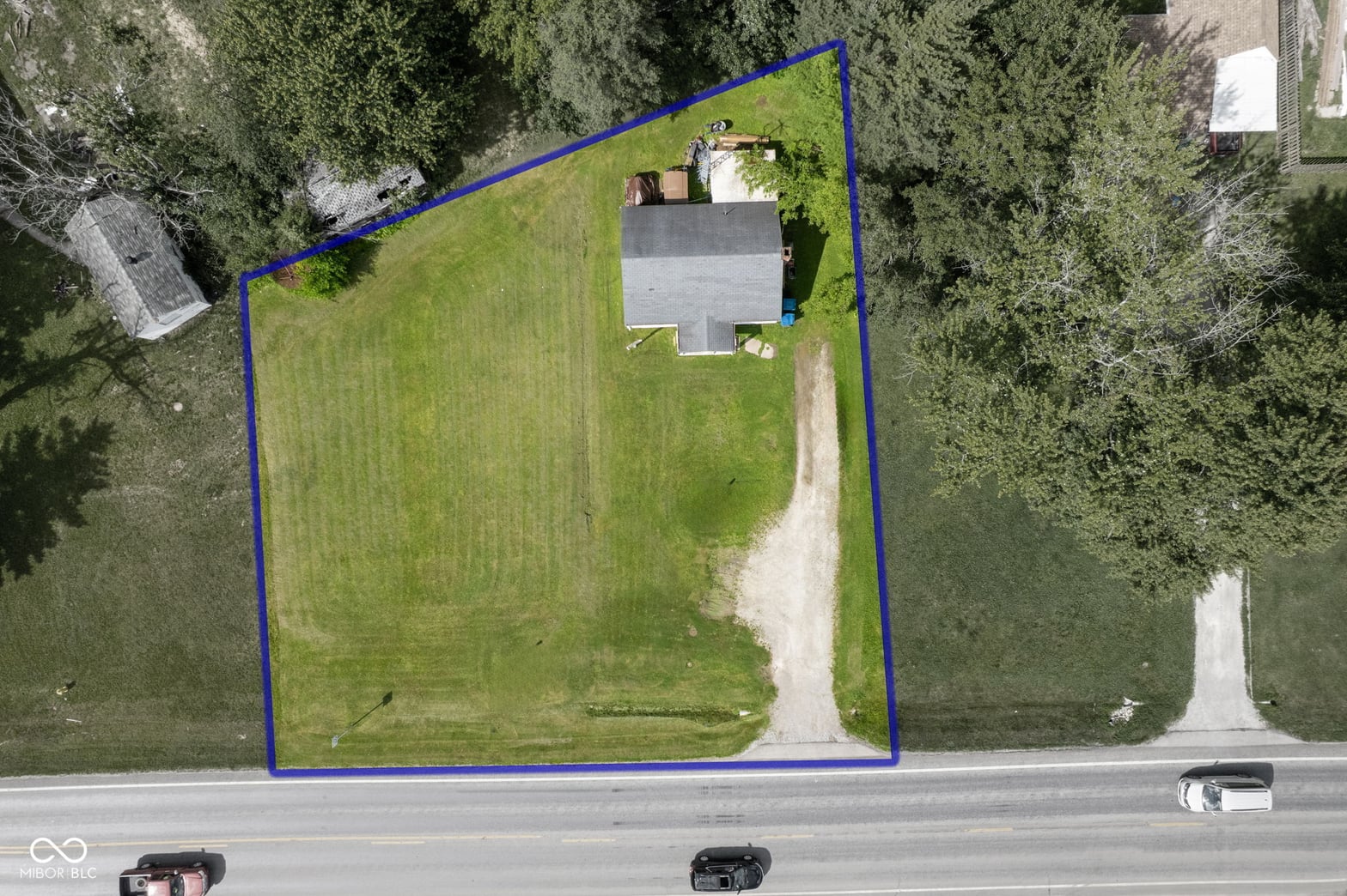 Aerial view at 2710 W State Road 38, Sheridan, IN — Expansive wooded lot with mature trees and open yard.