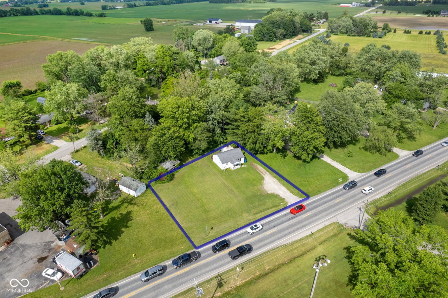 Aerial view at 2710 W State Road 38, Sheridan, IN — Spacious rural property with mature trees and road access.