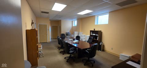 Home office at 22 W 8th Street, Anderson, IN — Spacious office with large conference table setup.