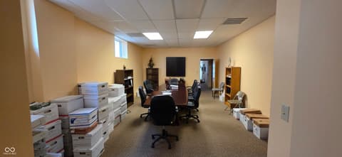 Home office at 22 W 8th Street, Anderson, IN — Spacious office with conference area and ample storage.