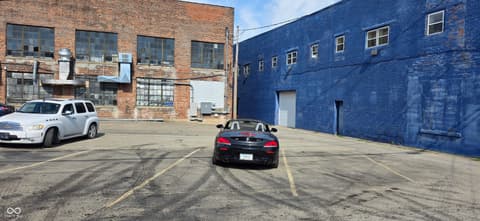 Front exterior at 22 W 8th Street, Anderson, IN — Spacious industrial lot with character brick buildings.
