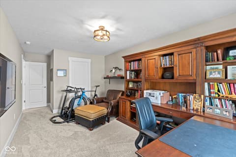 Bonus room at 14442 Treasure Creek Lane, Fishers, IN — Versatile bonus room with built-in storage and workspace.