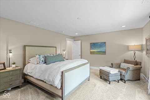 Primary bedroom at 14442 Treasure Creek Lane, Fishers, IN — Spacious primary suite with sitting area and ensuite access.