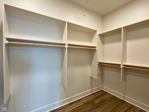 Primary bedroom at 925 Veterans Way, Carmel, IN — Luxury walk-in closet with custom shelving and lighting.