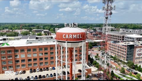 Aerial view at 925 Veterans Way, Carmel, IN — Iconic Carmel water tower with vibrant urban downtown views.
