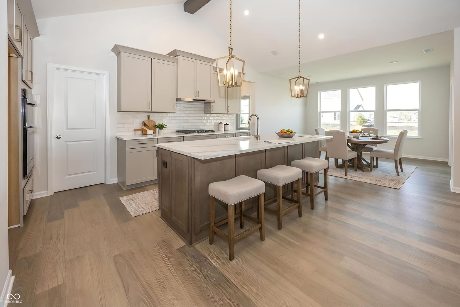 Bright open-concept kitchen with large island and dining area.