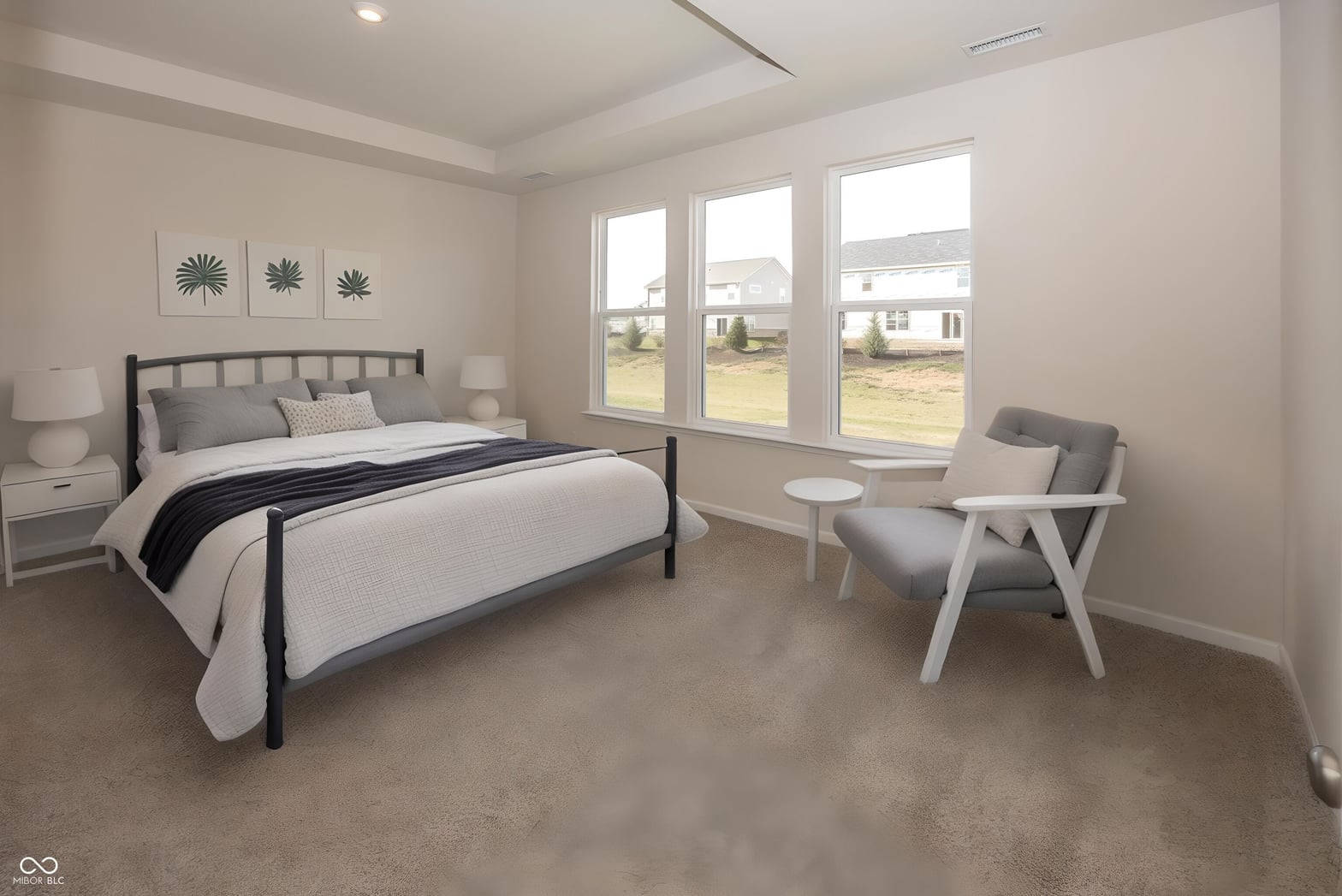 Spacious primary bedroom with abundant natural light and views.