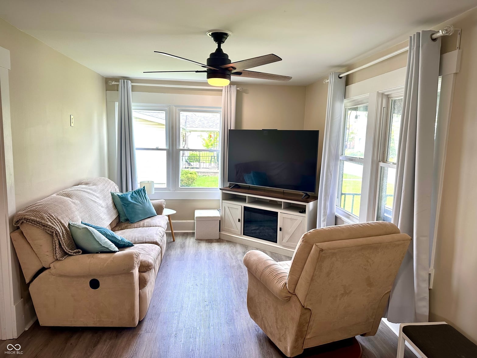 Living room at 514 E 2nd Street, Sheridan, IN — Bright living room with fireplace and patio access doors.