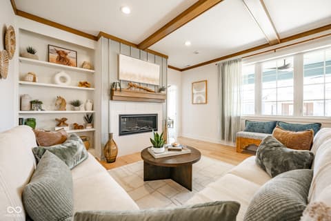 Living room at 14565 Bedford Falls Drive, Carmel, IN — Bright farmhouse living room with fireplace and built-ins.