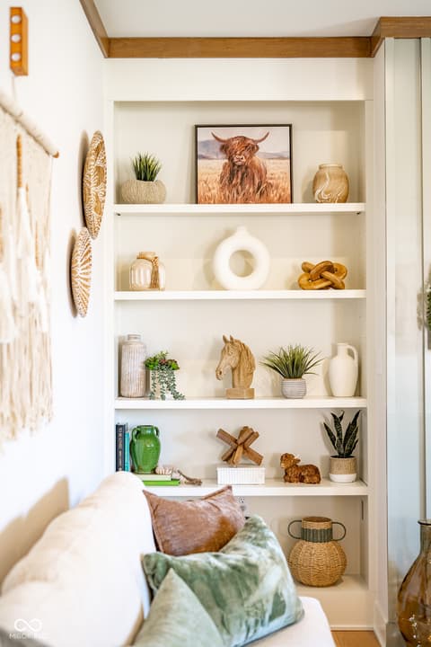 Living room at 14565 Bedford Falls Drive, Carmel, IN — Stylish built-in shelving with farmhouse décor styling.