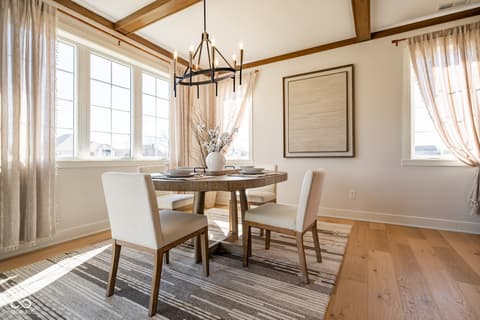 Dining room at 14565 Bedford Falls Drive, Carmel, IN — Bright dining room with exposed beams and abundant windows.