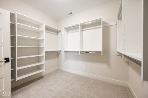 Primary bedroom at 14565 Bedford Falls Drive, Carmel, IN — Spacious walk-in closet with abundant organized storage.