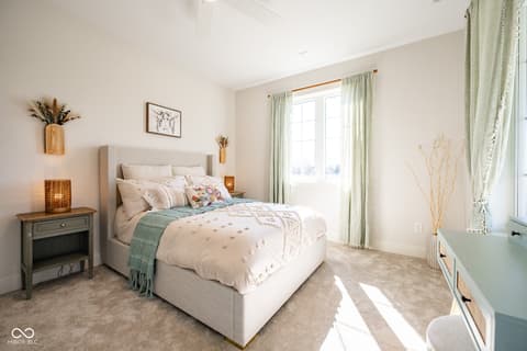 Primary bedroom at 14565 Bedford Falls Drive, Carmel, IN — Bright primary bedroom with glass doors and farmhouse style.