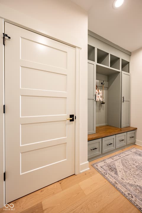 Foyer at 14565 Bedford Falls Drive, Carmel, IN — Luxurious foyer with custom cabinetry and hardwood floors.
