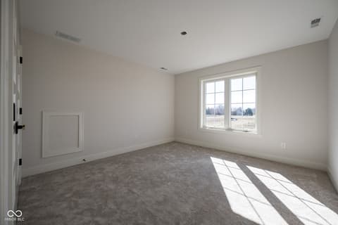 Bedroom at 14565 Bedford Falls Drive, Carmel, IN — Spacious bedroom with abundant natural light and views.