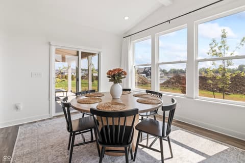 Dining room at 1438 Chatham Hills Boulevard, Westfield, IN — Bright dining room with expansive windows and outdoor views.