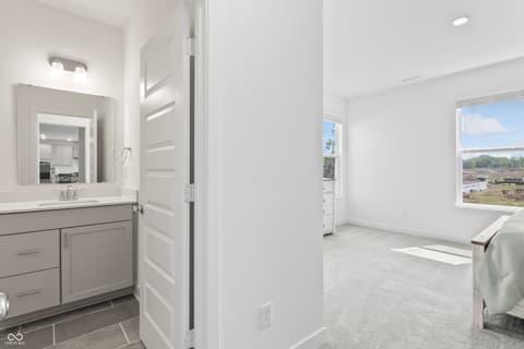 Primary bathroom at 1438 Chatham Hills Boulevard, Westfield, IN — Luxurious primary bath with double vanity and views.