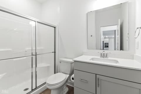 Primary bathroom at 1438 Chatham Hills Boulevard, Westfield, IN — Sleek primary bath with frameless shower and double vanity.