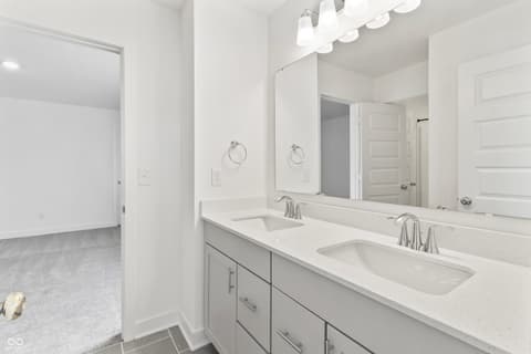 Primary bathroom at 1438 Chatham Hills Boulevard, Westfield, IN — Spacious primary bath with dual vanity and quartz counters.